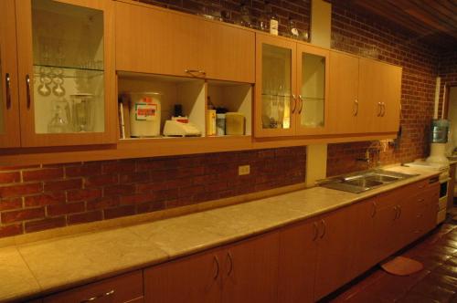 a kitchen with wooden cabinets and a sink at Villa del Mar in Mactan