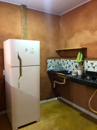 a white refrigerator in a kitchen with a counter at Recanto do Vale in Pirenópolis