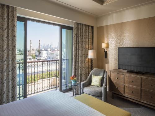 a hotel room with a bed and a large window at Four Seasons Resort Dubai at Jumeirah Beach in Dubai