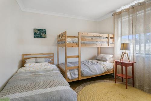 a bedroom with two bunk beds and a window at Sunnyside in Katoomba