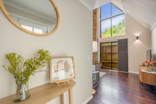 a mirror on the wall in a living room at Edelweiss Leura in Leura