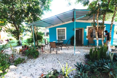 a blue house with a table and chairs in front of it at Otoch Béek Calakmul in Chicanna