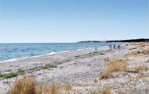 a group of people on a beach near the water at Holiday Home Aresvej Ebeltoft Xii in Ebeltoft