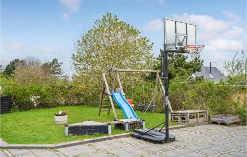 a basketball hoop in a yard with a playground at Holiday Home Aresvej Ebeltoft Xii in Ebeltoft