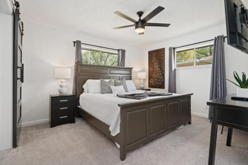a bedroom with a bed and a ceiling fan at The Gated Modern Home Near NRG and Medical Center in Houston