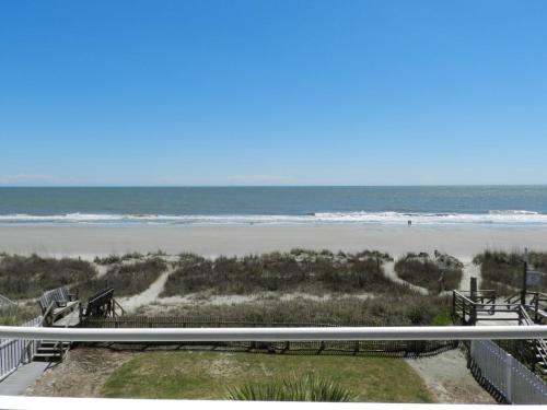 a view of the beach from the balcony of a beach house at Boston Commons 201 Condo in Myrtle Beach