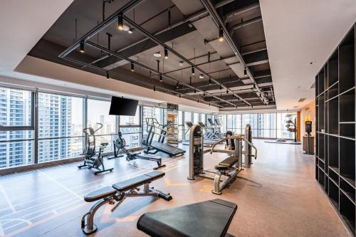 a gym with treadmills and cardio equipment in a building at EVEN Suzhou Grand Canal by IHG in Suzhou
