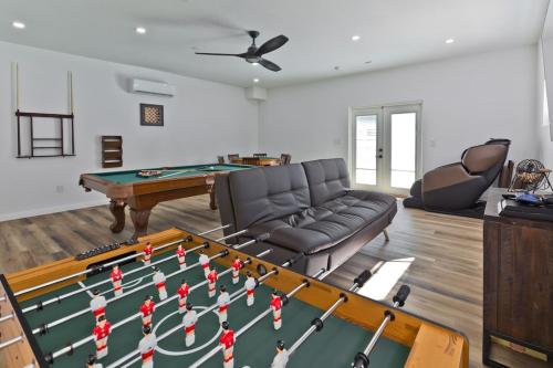 a living room with a pool table and a couch at Big Horn Desert Estate Luxury Smarthome - Amazing Pool & Game Room! in Palm Desert