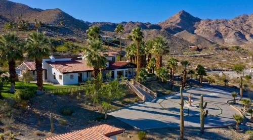 an aerial view of a house with palm trees and mountains at Big Horn Desert Estate Luxury Smarthome - Amazing Pool & Game Room! in Palm Desert
