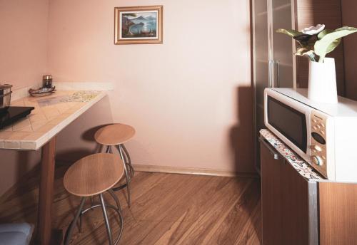 a kitchen with a counter and a refrigerator with stools at Relax Brugnato in Brugnato