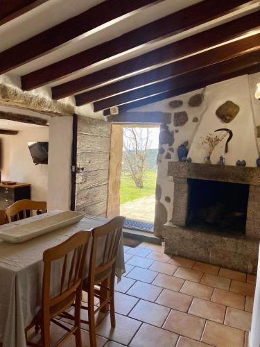 une salle à manger avec une table et une cheminée dans l'établissement BERGERIE PARADISU, Domaine de l Ogliastru, à Olmeto