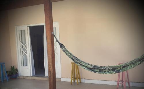 a hammock in a room next to a door at Casa# Cantinho do Sossego in São Francisco do Sul