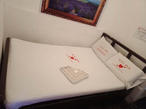 a white bed with two white pillows on it at WJV INN Mandaue Centro in Mandaue City