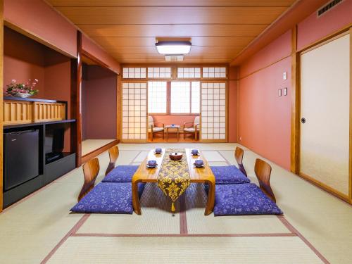 a dining room with a table and chairs at Fukui Hotel in Obihiro