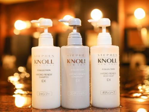 a group of three bottles of shampoo and conditioner on a table at Fukui Hotel in Obihiro
