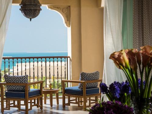 a balcony with chairs and a view of the beach at Four Seasons Resort Dubai at Jumeirah Beach in Dubai