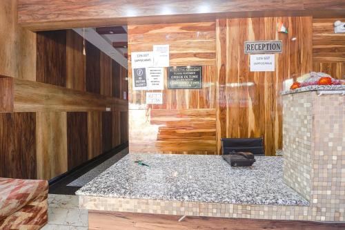 a room with wooden walls and a room with a counter at FabHotel Royal Aanandam in Gwalior