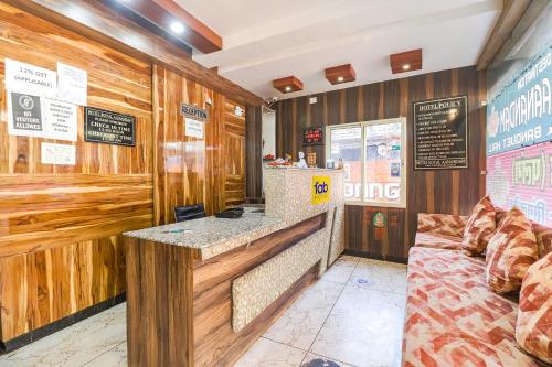 a bar in a restaurant with wooden walls at FabHotel Royal Aanandam in Gwalior