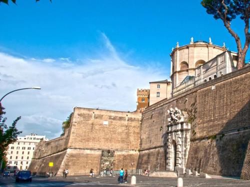 een groot bakstenen gebouw waar mensen voor lopen bij Vatican Dream in Rome