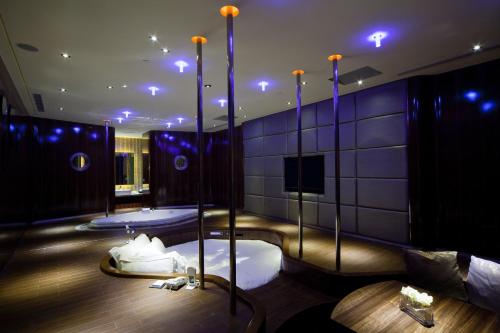 a room with two beds in a room with blue lights at Wego Funtel - Dazhi Branch in Taipei