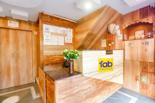 a room with wooden walls and a counter with flowers on it at FabExpress Ambika Dx in Gwalior