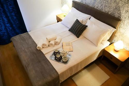 a small bed with a tray of food on it at Apartments Novis - close to the sea in Kali