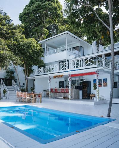 a house with a swimming pool in front of a house at Casa De Lipe Pool Villa in Ko Lipe