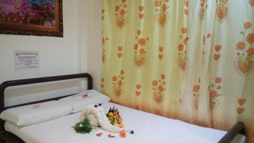 a bedroom with a bed with flowers on it at WJV INN Bankal in Bankal