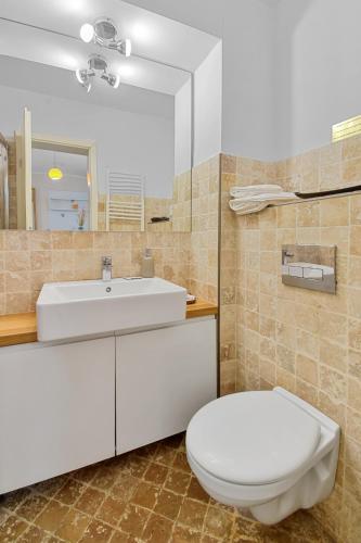 a bathroom with a white toilet and a sink at Bella Studio in Braşov