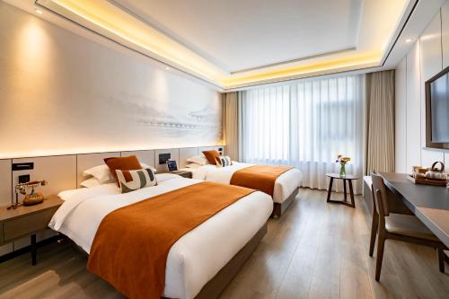 Postel nebo postele na pokoji v ubytování Cheng Jin Hotel