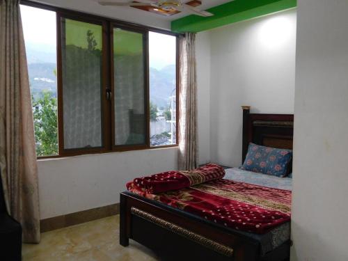 Ліжко або ліжка в номері New Balakot Hotel