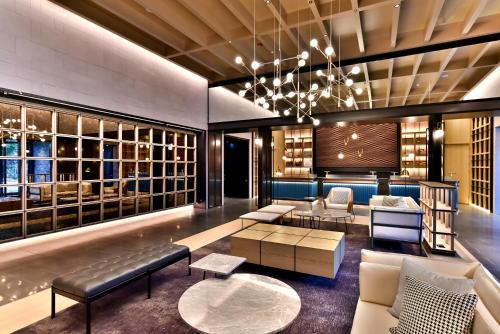 a lobby of a hotel with couches and tables at Four Points by Sheraton Taipei Bali in Bali