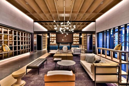 a lobby with couches and tables and a chandelier at Four Points by Sheraton Taipei Bali in Bali