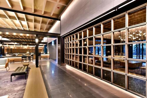 a lobby of a hotel with a bench and windows at Four Points by Sheraton Taipei Bali in Bali