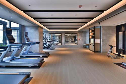 a gym with treadmills and elliptical machines at Four Points by Sheraton Taipei Bali in Bali