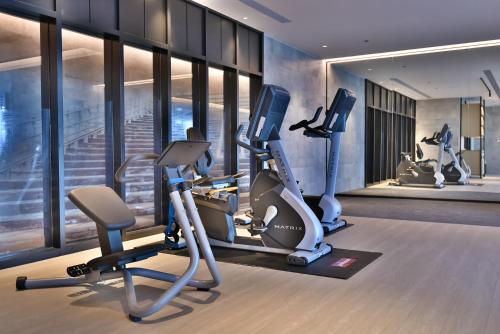 a gym with treadmills and ellipticals in a building at Four Points by Sheraton Taipei Bali in Bali