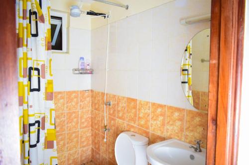 a bathroom with a toilet and a sink at Havan Furnished Apartments-Milimani N8 in Nakuru