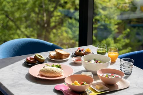 a table with breakfast foods and drinks on it at W Osaka in Osaka