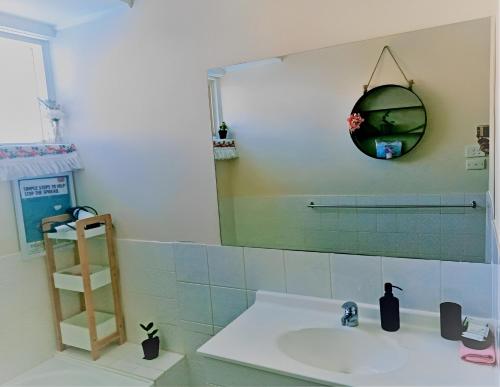 a bathroom with a sink and a mirror at 2BR house in West Lamington in Kalgoorlie