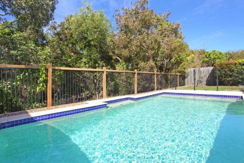 a swimming pool in front of a fence at 15 Wave Crescent in Marcoola