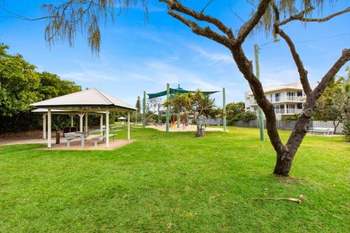 a park with a bench and a gazebo at Unit 2 Marcoola Sands in Marcoola