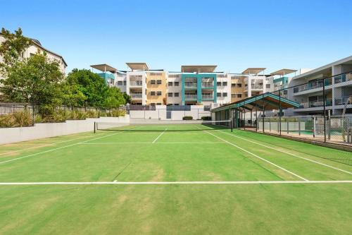 a tennis court in front of a apartment building at Unit 30-31 12 Perry Street in Coolum Beach