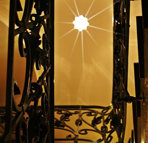 a reflection of a light in a mirror at Duval Apartments in Warsaw