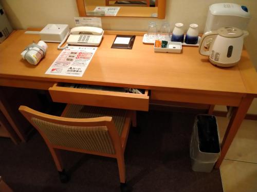 a wooden desk with a coffee maker on it at Smile Hotel Nara in Nara