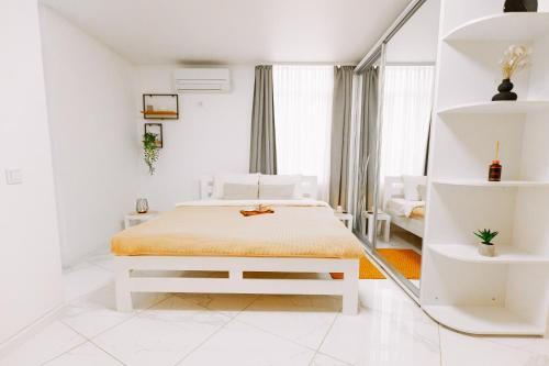 a white bedroom with a bed and a window at Black&White Нова стильна квартира на Київській in Ternopilʼ