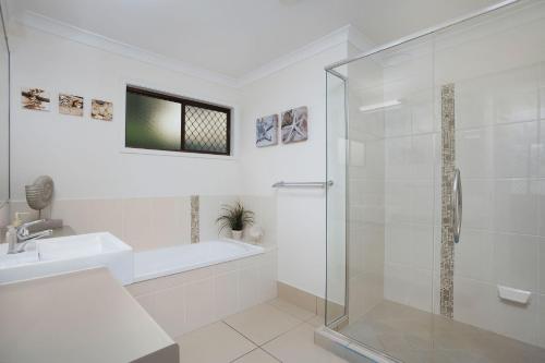 a bathroom with a shower and a sink at 22 Sorrento Avenue in Coolum Beach