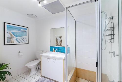 a bathroom with a shower and a sink and a toilet at Unit 2 Coolum Terraces in Coolum Beach