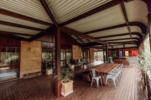 a large deck with a wooden table and chairs at Balingup Jalbrook Cottages Jalbrook Estate in Balingup