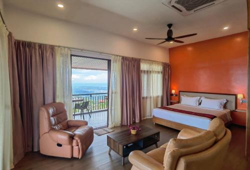 a hotel room with a bed and a balcony at Kokol Haven Resort in Kota Kinabalu