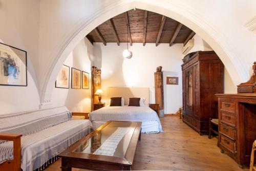 two beds in a room with an arched ceiling at Kalavasos Square Apartments - With Access to Shared Pool 3 Minutes Walk in Kalavasos